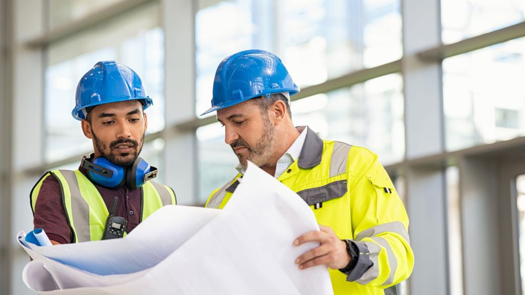 Two Building contractors discussing plans on Devon project