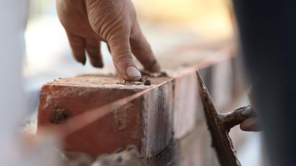 Close up of a brick layer at work