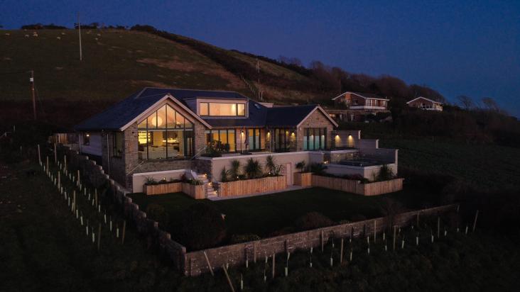 Ariel view at night of La mer a luxurious bespoke hose in Saunton built by Pearce Construction