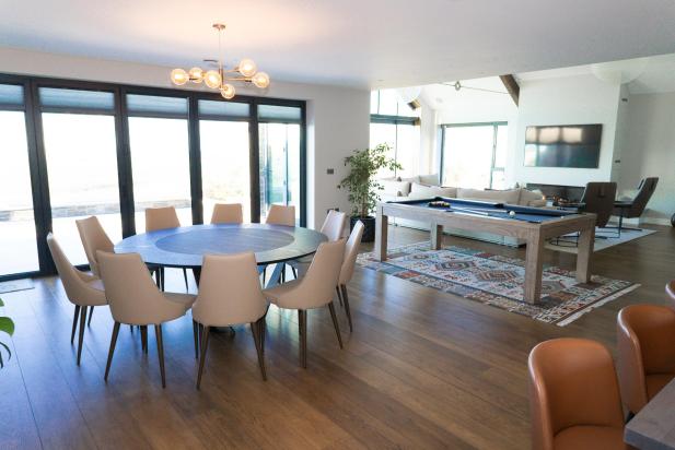 Living area of bespoke luxurious home with pool table and large television on wall