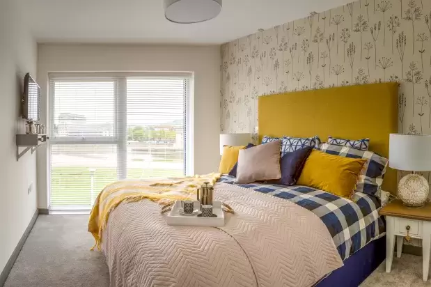 Master bedroom with a king size bed and blinds on window