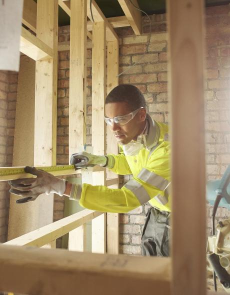 Joiner building stud wall in new home