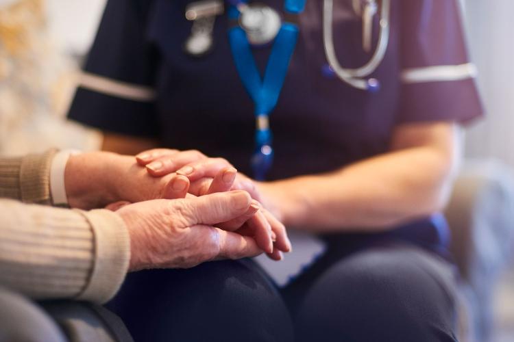 Hospice Nurse giving care to elderly patient