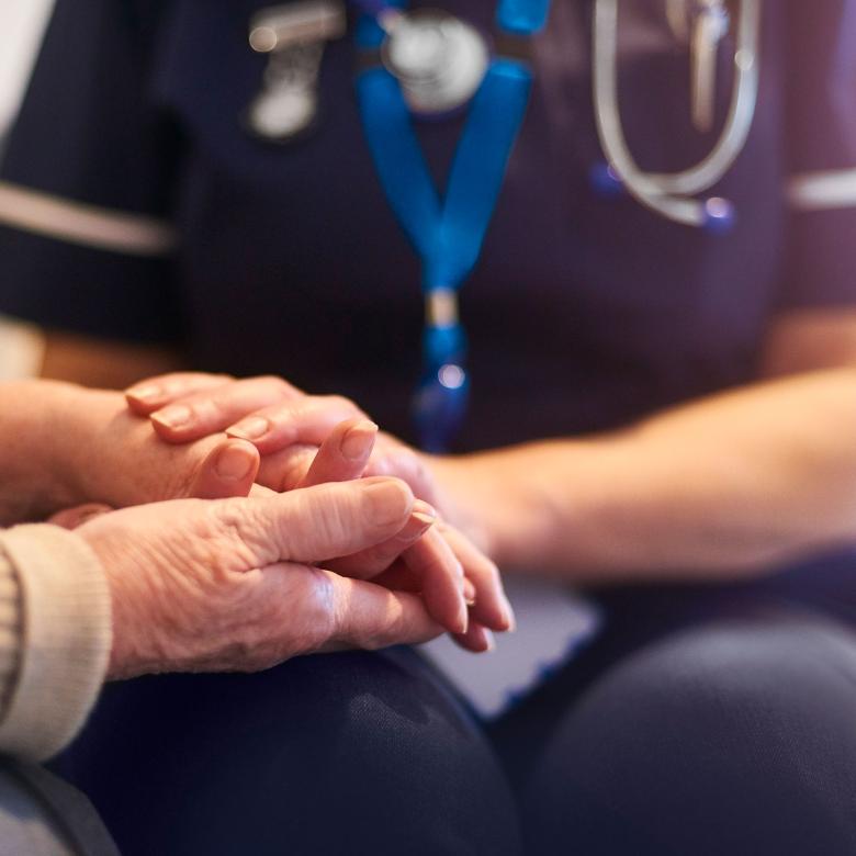 Hospice Nurse giving care to elderly patient