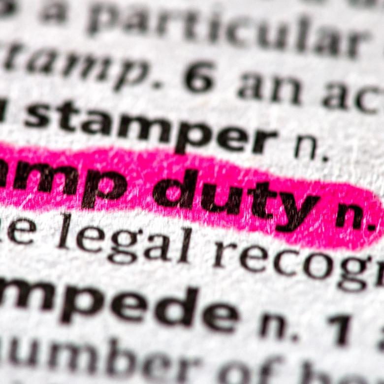 Stamp Duty Definition in dictionary highlighted with pink marker pen